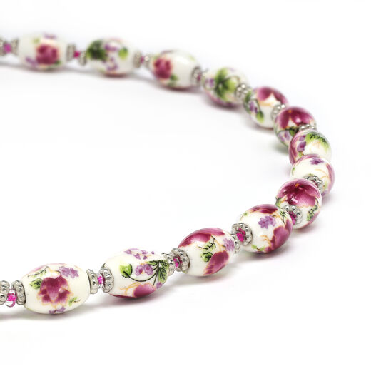 A close up of the white ceramic beads and the floral pink pattern.